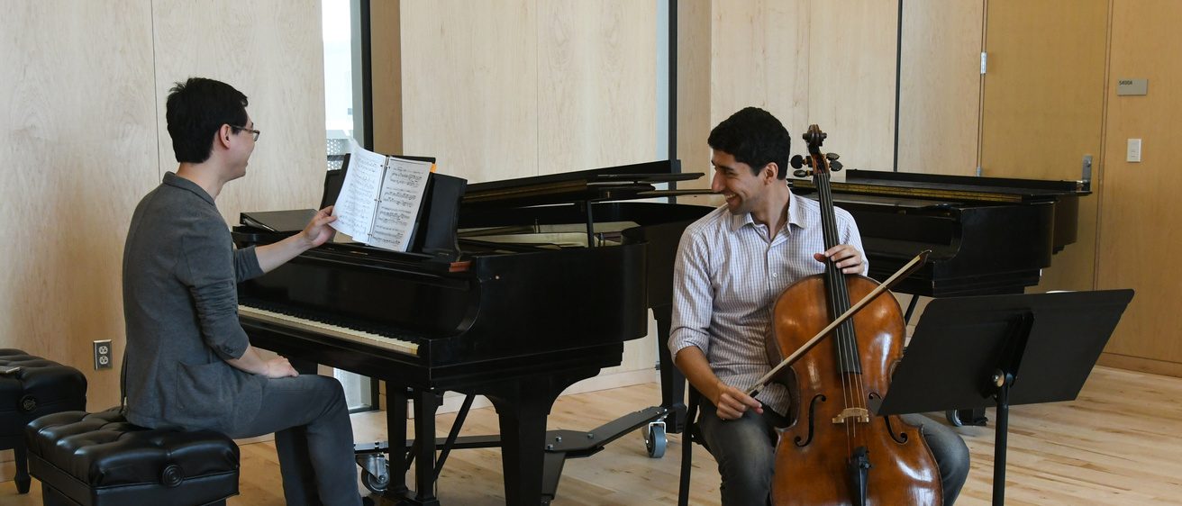 a collaborative pianist (left) prepares to play music alongside a cellist (right)