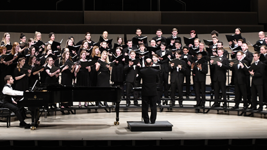 A wide photograph of a School of Music choir ensemble